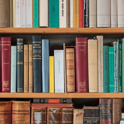 Part of a bookshelf containing books by ancient philosophers 1.1