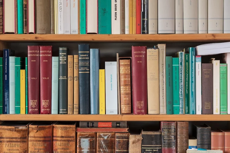 Part of a bookshelf containing books by ancient philosophers 1.1